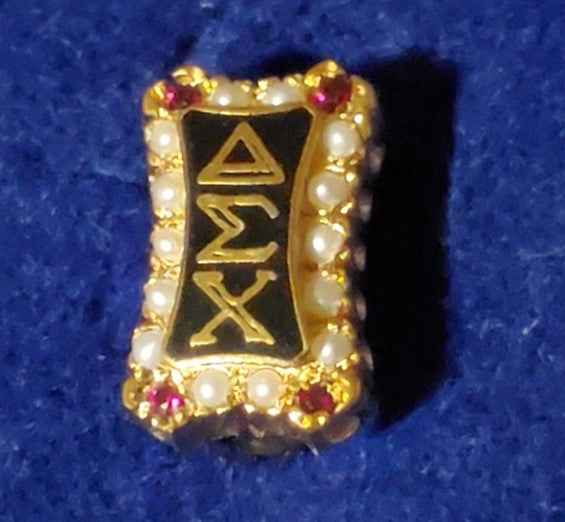 1920’s vertical, crown-set badge w/garnets and pearls